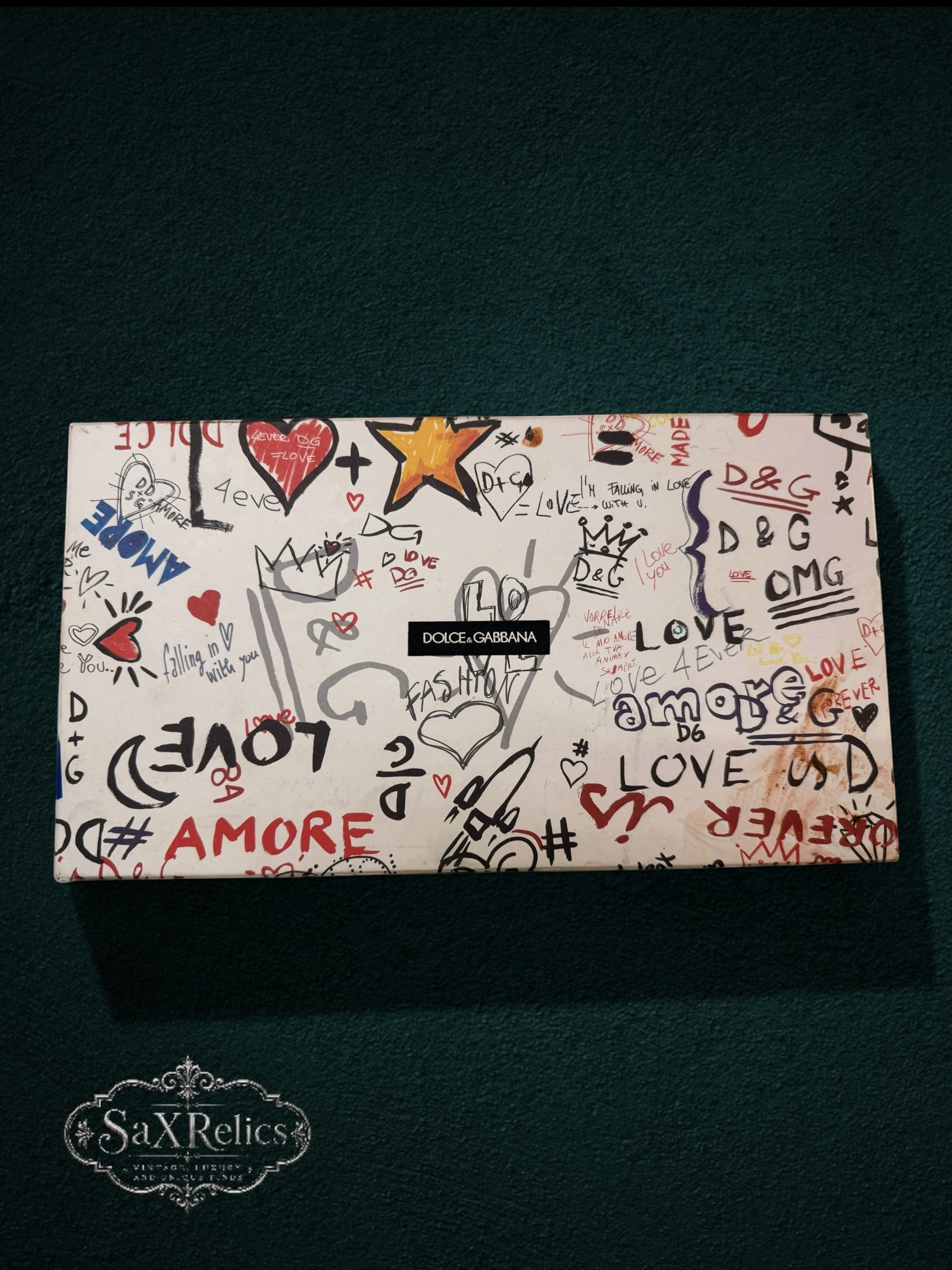 Dolce & Gabbana embellished slide sandals box with graffiti-style art, featuring 'Love' and 'Amore' text, hearts, and stars.