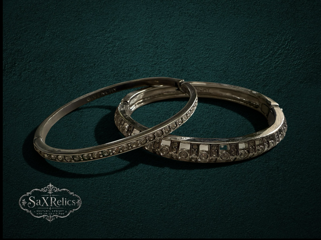 My Store vintage Givenchy silver-tone hinged bangle bracelet set with sparkling clear crystals on dark green background.