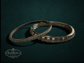 My Store vintage Givenchy silver-tone hinged bangle bracelet set with sparkling clear crystals on dark green background.