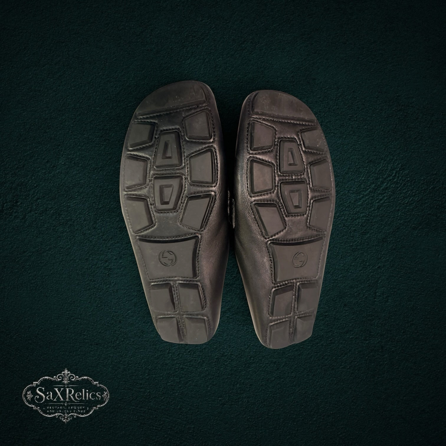 My Store Gucci black leather loafers featuring a durable rubber-pebble outsole for traction and comfort.