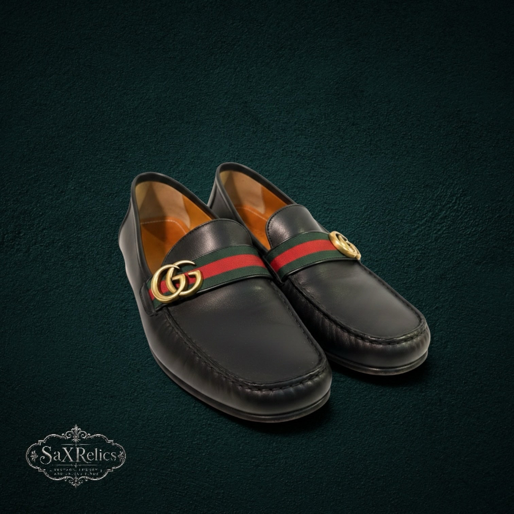 My Store black leather Gucci loafers featuring a signature web stripe and gold-tone interlocking GG hardware.