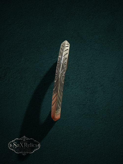 My Store handcrafted sterling silver cuff bracelet with intricate geometric engravings on a dark green background.