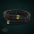 My Store Swarovski black crystal wrap bracelet with gold-tone end caps and iridescent purple and gold accents.