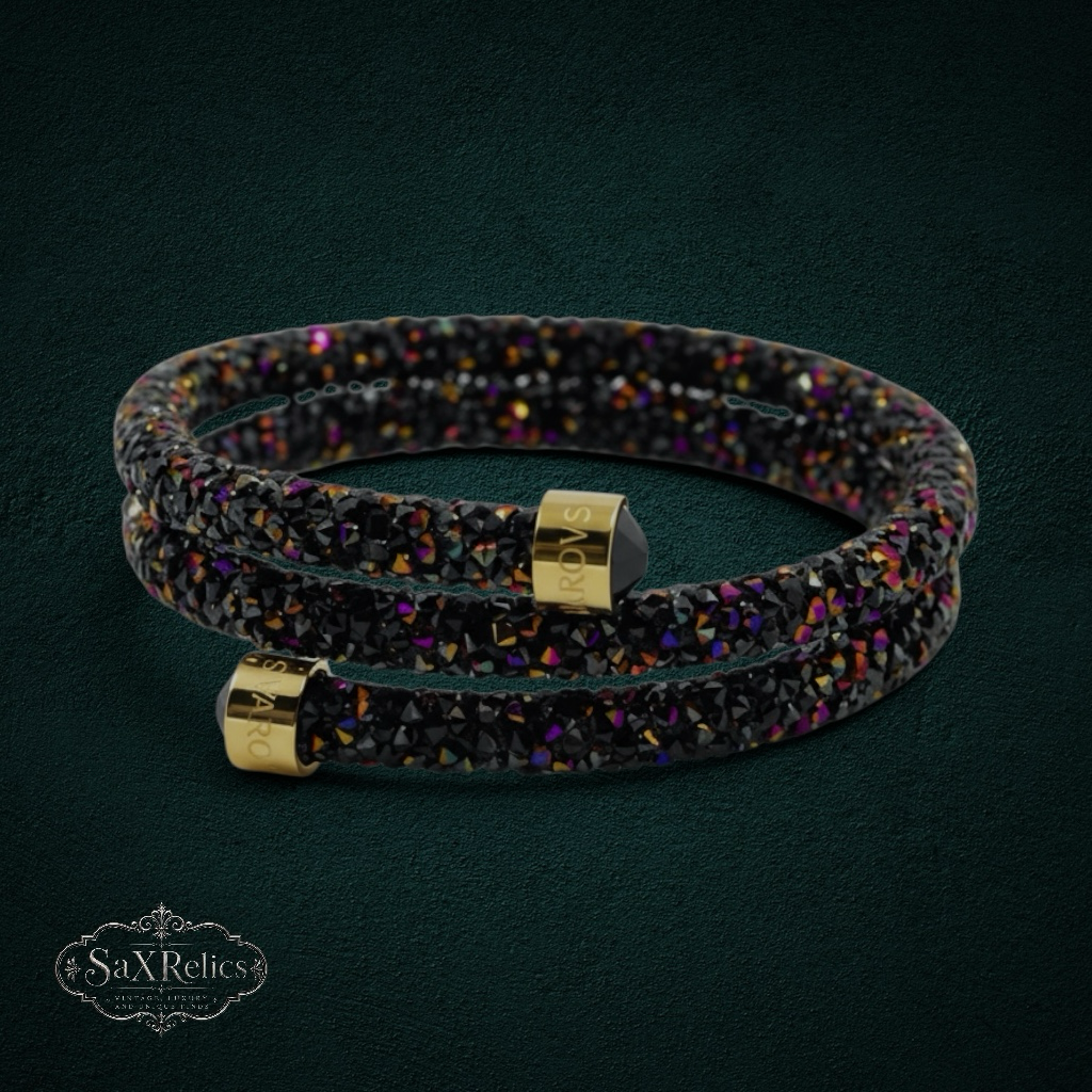 My Store Swarovski black crystal wrap bracelet with gold-tone end caps and iridescent purple and gold accents.
