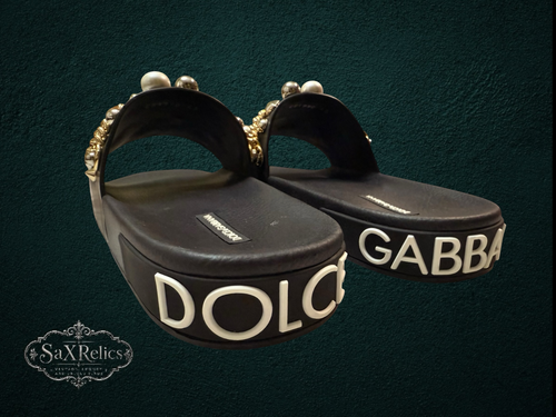 My Store Dolce & Gabbana black rubber slide sandals with pearl and gold-tone embellishments on straps and embossed logo on platform sole.